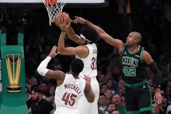 Boston Celtics center Al Horford (42) battles for a rebound against Cleveland Cavaliers center Jarrett Allen (31) during the first half of an Emirates NBA Cup basketball game, Tuesday, Nov. 19, 2024, in Boston. (AP Photo/Charles Krupa)