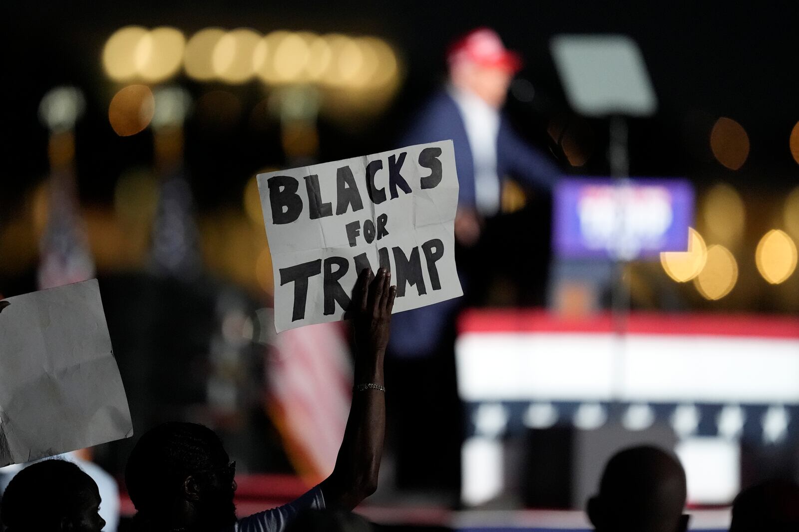 FILE - A supporter holds up a sign as Republican presidential candidate former President Donald Trump speaks at a campaign rally at Trump National Doral Miami, July 9, 2024, in Doral, Fla. (AP Photo/Rebecca Blackwell, File)