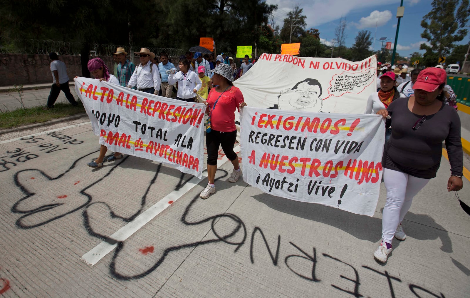 FILE - People protest the disappearance of 43 students from Raúl Isidro Burgos Rural Normal School and demand authorities find them, in Chilpancingo, Guerrero state, Mexico, Oct. 8, 2014. (AP Photo/Eduardo Verdugo, File)