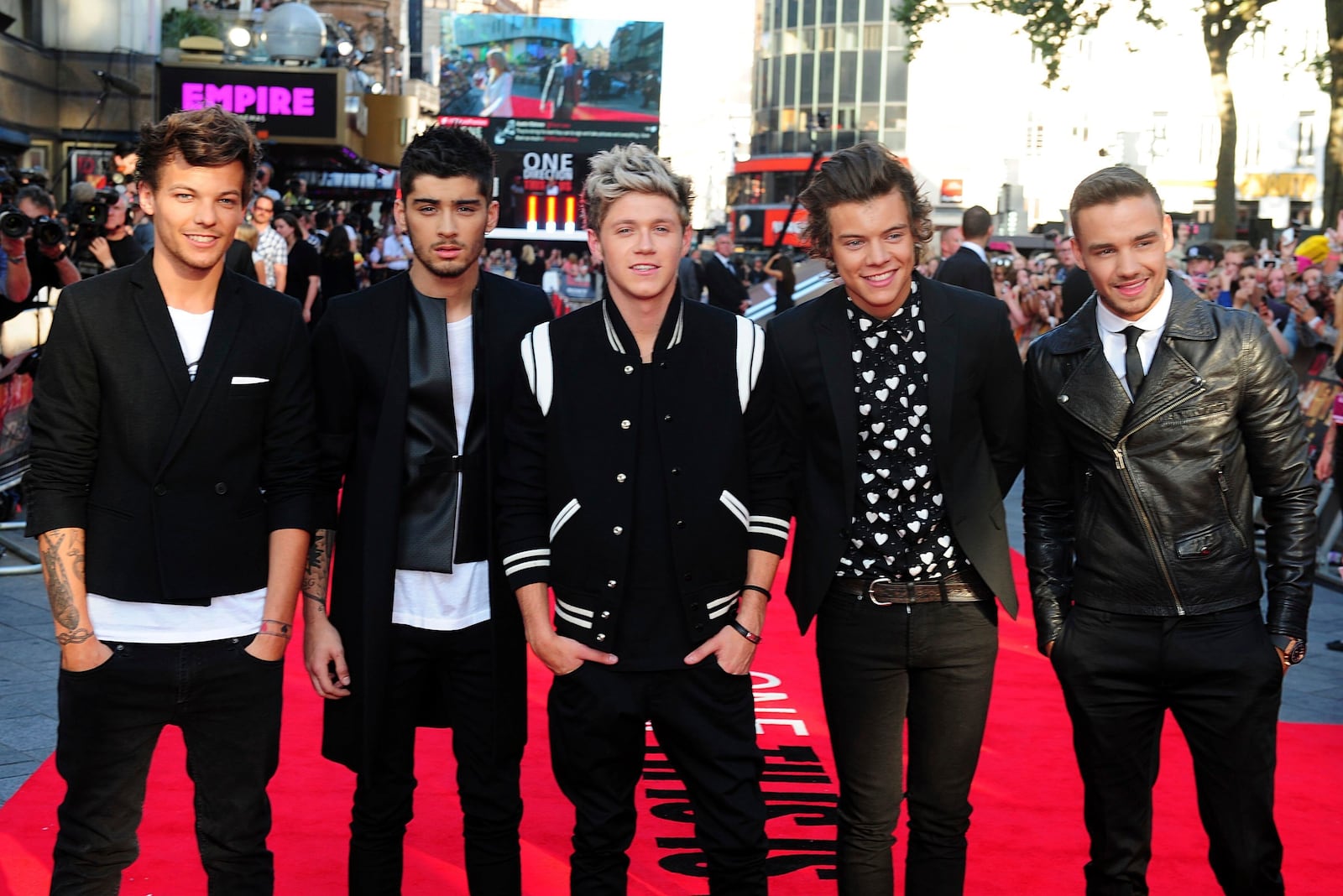 FILE - Louis Tomlinson, from left, Zayn Malik, Niall Horan, Harry Styles and Liam Payne arrive for the World Premiere of "One Direction: This Is Us," at the Empire Leicester Square, in London, Aug. 20, 2013. (Ian West/PA via AP, File)