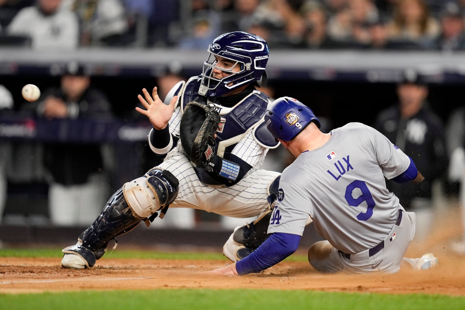 Los Angeles Dodgers' Gavin Lux scores past New York Yankees catcher Jose Trevino during the sixth inning in Game 3 of the baseball World Series, Monday, Oct. 28, 2024, in New York. (AP Photo/Ashley Landis)