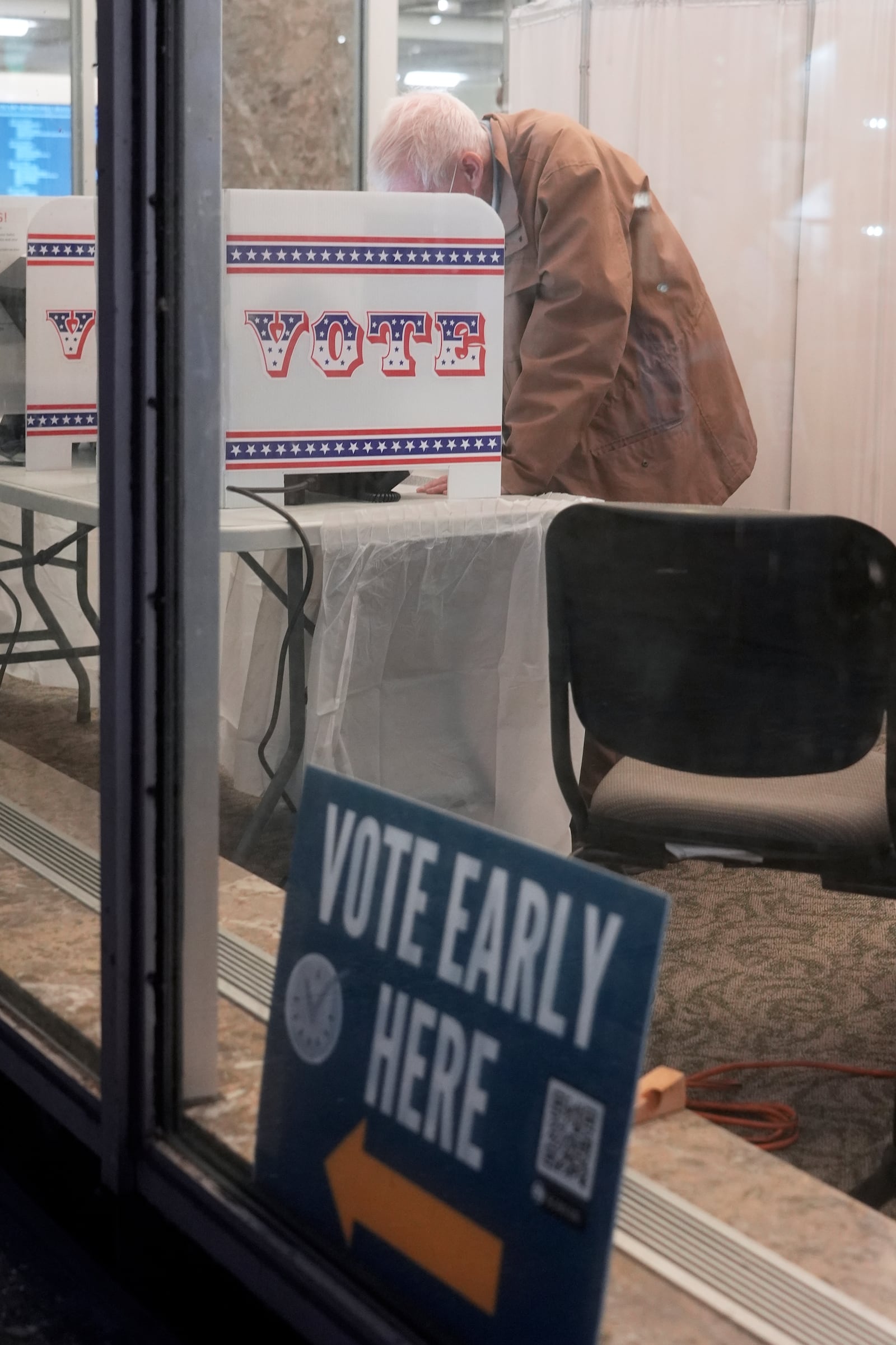 A voter casts his ballot at the Frank P. Zeidler Municipal Building during the first day of Wisconsin's in-person absentee voting Tuesday, Oct. 22, 2024, in Milwaukee. (AP Photo/Morry Gash)