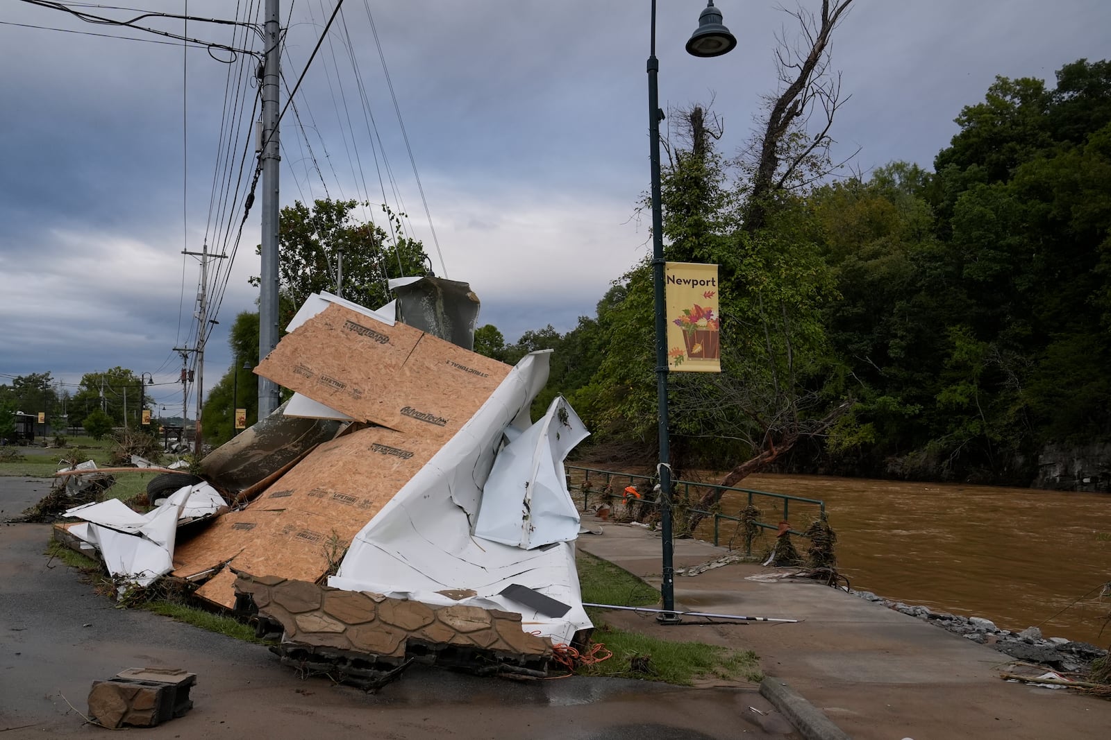 Flood debris along the Pigeon river left by tropical depression Helene is seen in Newport, Tenn., Saturday, Sept. 28, 2024. (AP Photo/George Walker IV)