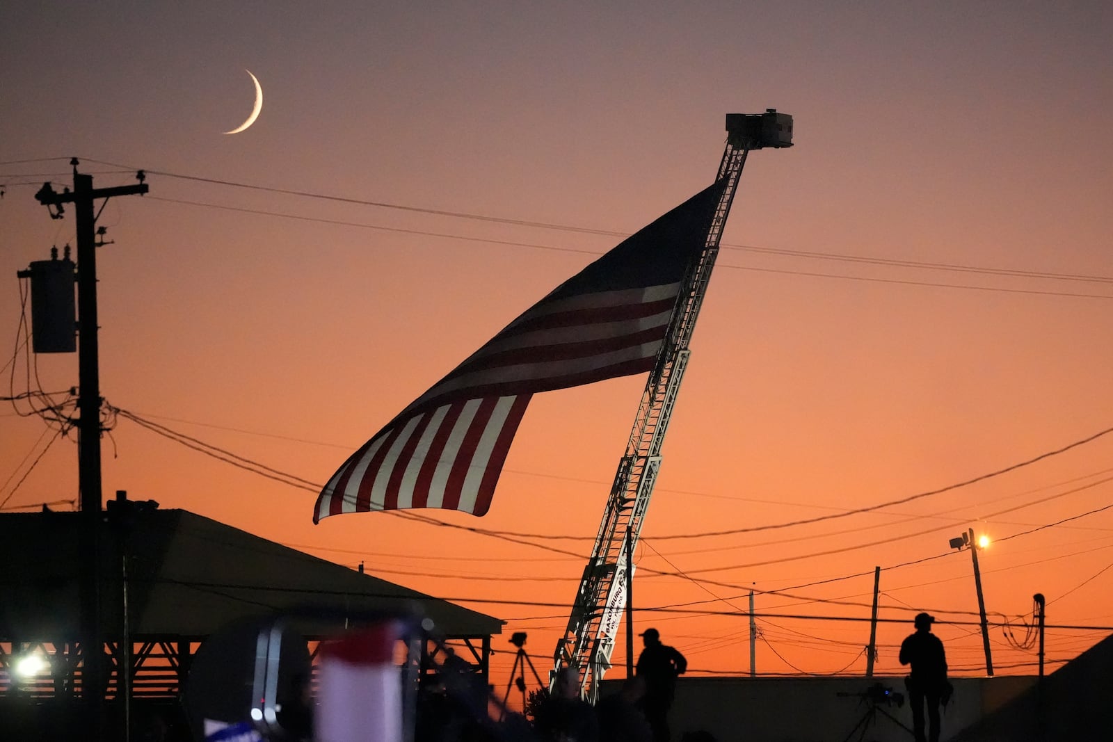 A flag waves as Republican presidential nominee former President Donald Trump speaks at a campaign event at the Butler Farm Show, Saturday, Oct. 5, 2024, in Butler, Pa. (AP Photo/Alex Brandon)