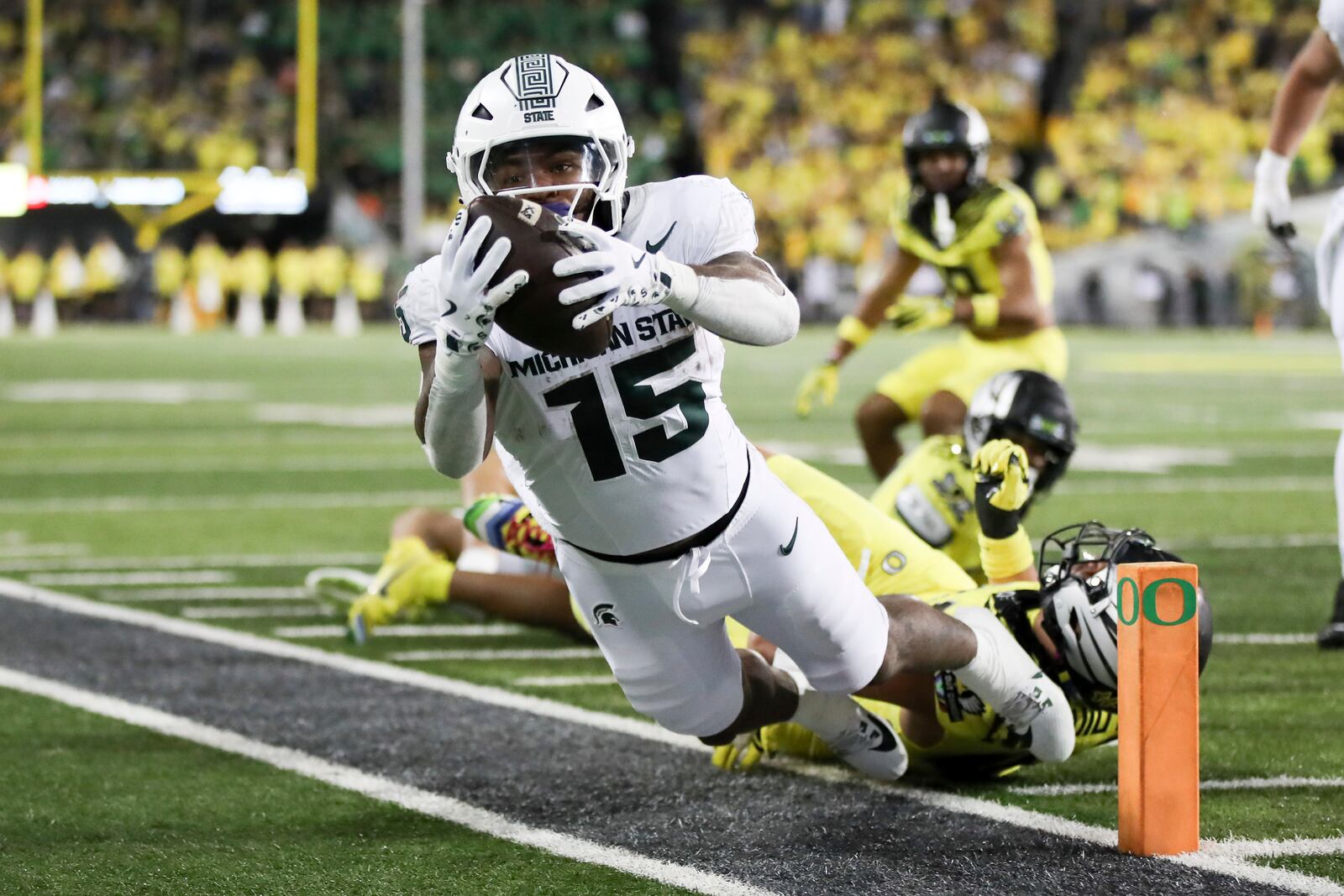 Michigan State running back Kay'Ron Lynch-Adams, left, is tackled out of bounds by Oregon linebacker Teitum Tuioti, right, during the second half of an NCAA college football game, Friday, Oct. 4, 2024, in Eugene, Ore. Oregon won 31-10. (AP Photo/Amanda Loman)