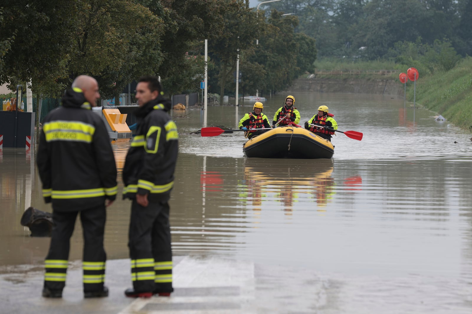 Firefighters use a dingy boat to reach civilians to be evacuated after flooding in Faenza, in the region of Emilia Romagna, Italy, Thursday, Sept. 19, 2024. (Fabrizio Zani/LaPresse via AP)