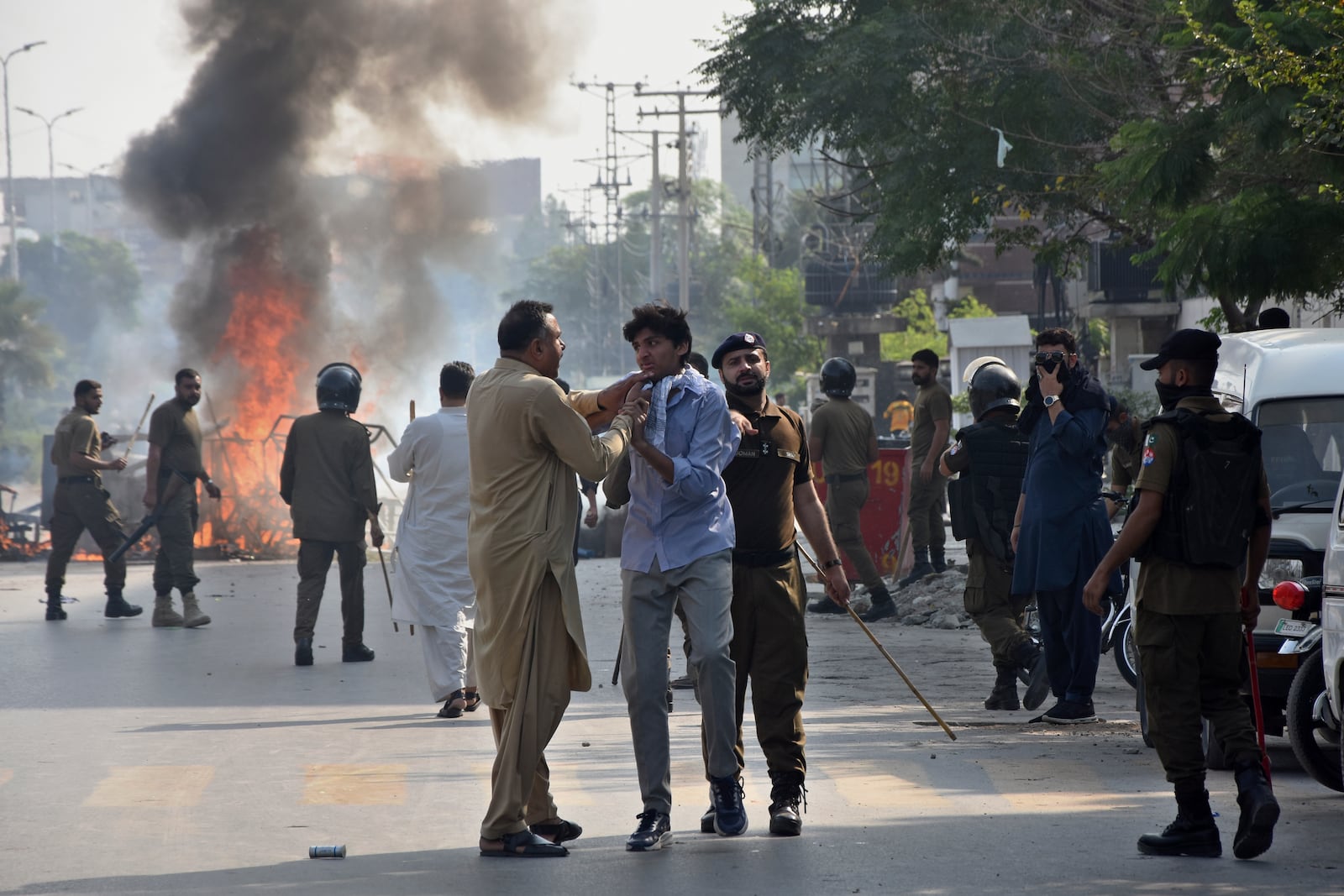 A plainclothes police officer detains a demonstrator during a students' protest over an alleged on-campus rape in Punjab, in Rawalpindi, Pakistan, Thursday, Oct. 17, 2024. (AP Photo/W.K. Yousafzai)