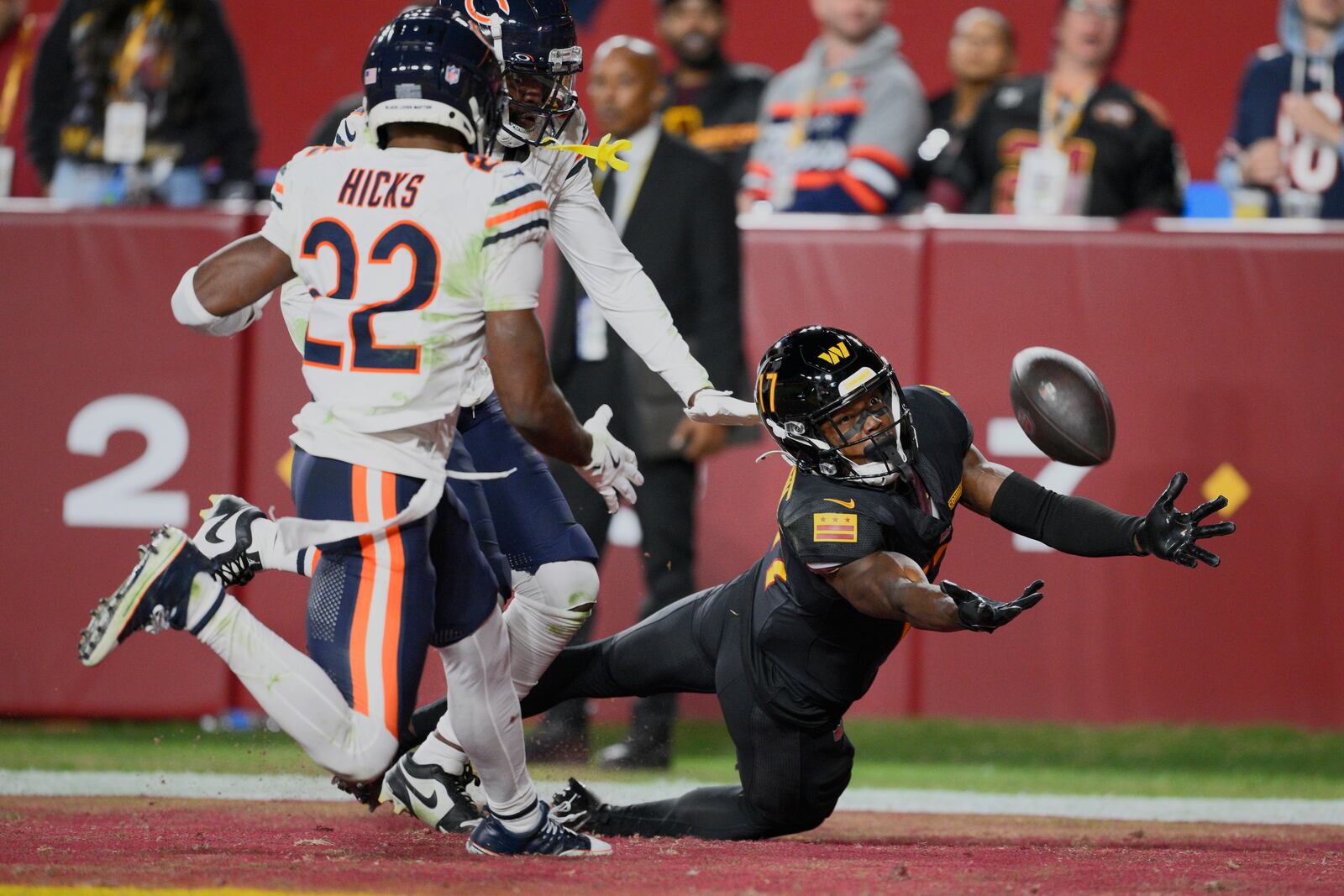 Washington Commanders wide receiver Terry McLaurin (17) reaches for a pass ruled incomplete as he is defended by Chicago Bears safety Elijah Hicks (22) in the second half of an NFL football game Sunday, Oct. 27, 2024, in Landover, Md. (AP Photo/Nick Wass)