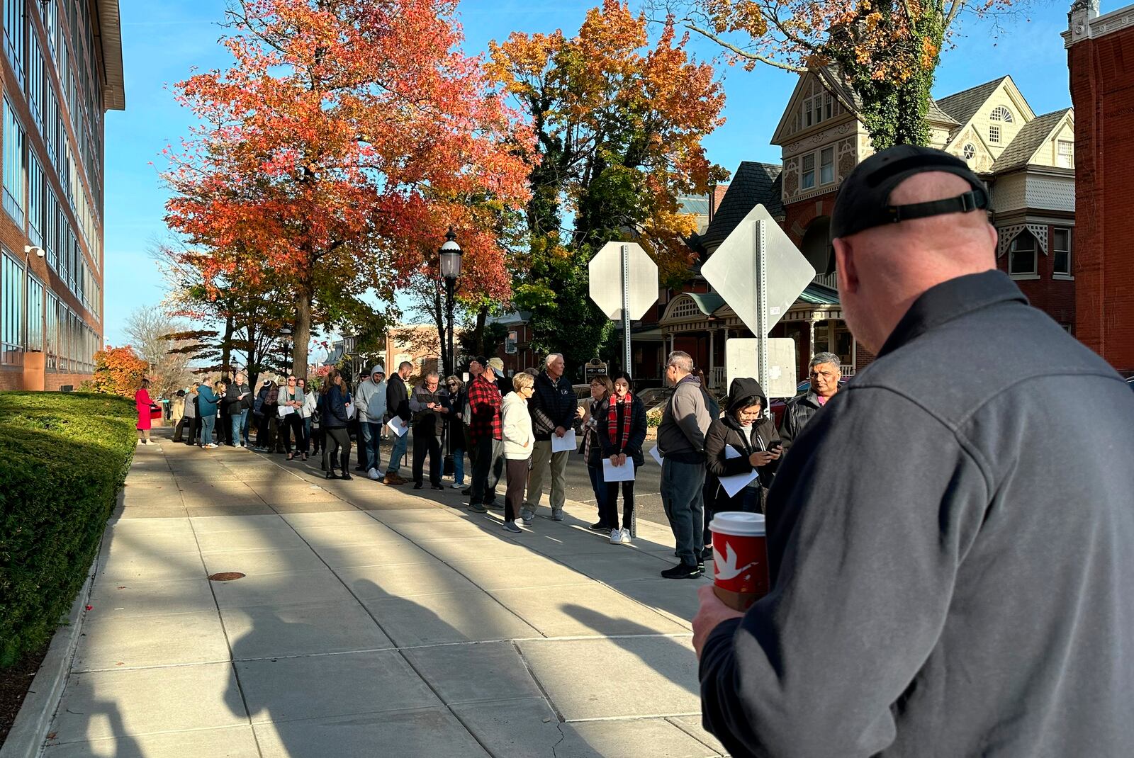 People wait in line outside the Bucks County government building to apply for an on-demand mail ballot on the last day to request one in Doylestown, Pa., Tuesday, Oct. 29, 2024. (AP Photo/Mike Catalini)