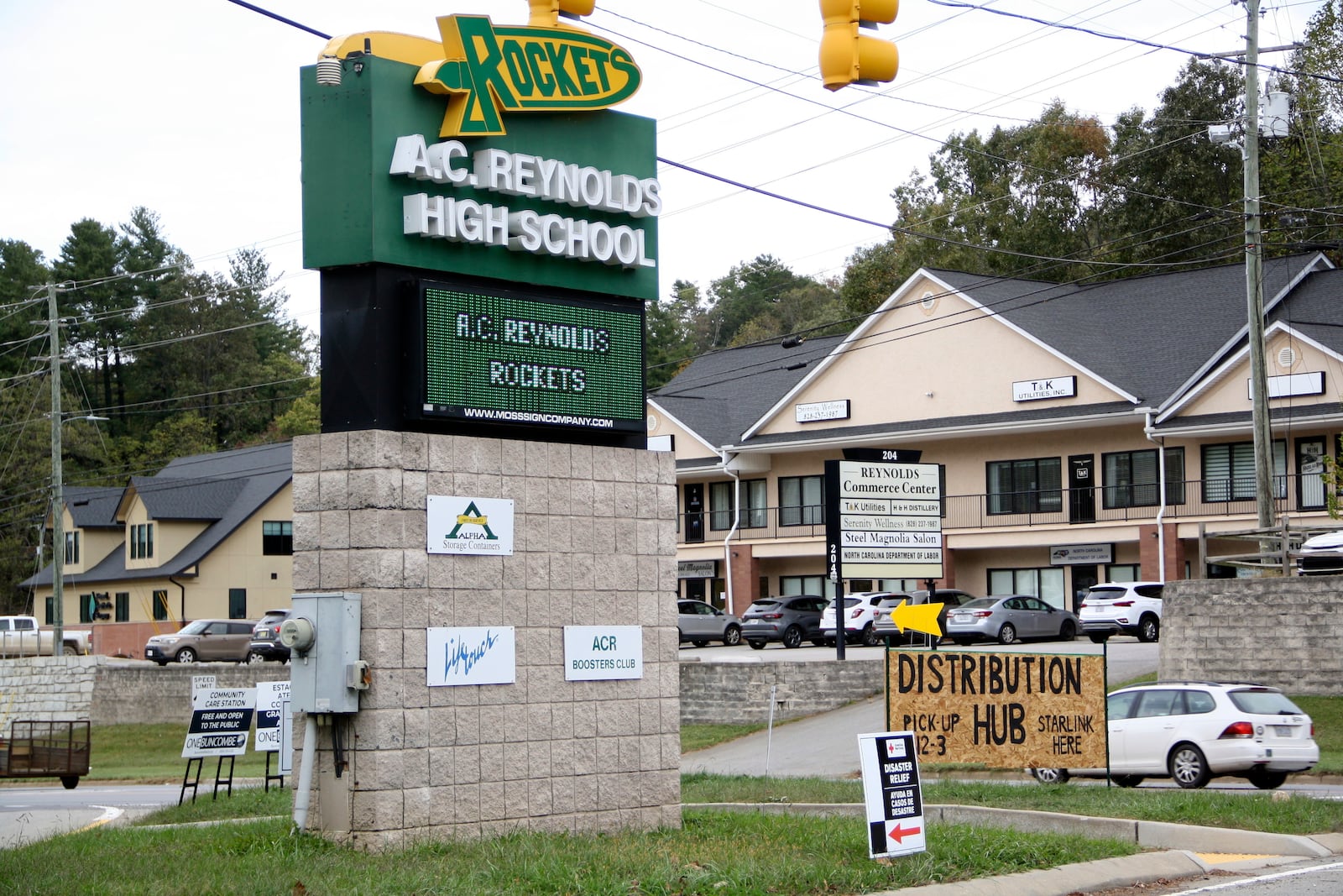 Signs are seen at a FEMA Disaster Recovery Center at A.C. Reynolds High School in Asheville, N.C., Tuesday, Oct. 15, 2024. (AP Photo/Makiya Seminera)