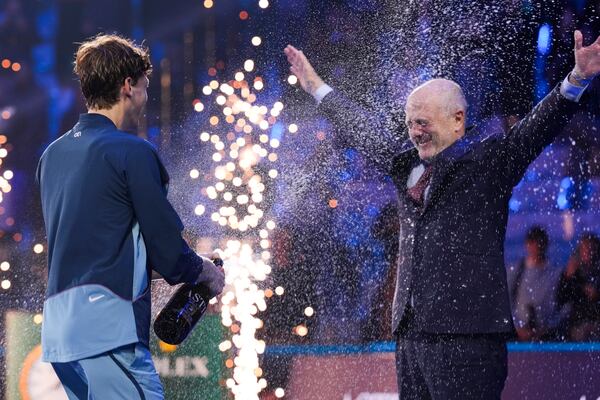 Italy's Jannik Sinner sprays Angelo Binaghi, the President of the Italian Tennis Federation, after winning the final match of the ATP World Tour Finals against Taylor Fritz of the United States at the Inalpi Arena, in Turin, Italy, Sunday, Nov. 17, 2024. (AP Photo/Antonio Calanni)