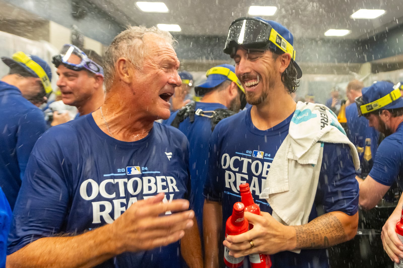 Hall of Fame Kansas City Royals' infielder George Brett, left, celebrates with pitcher Michael Lorenzen, right, in the locker room after a baseball game against the Atlanta Braves, Friday, Sept. 27, 2024, in Atlanta. (AP Photo/Jason Allen)