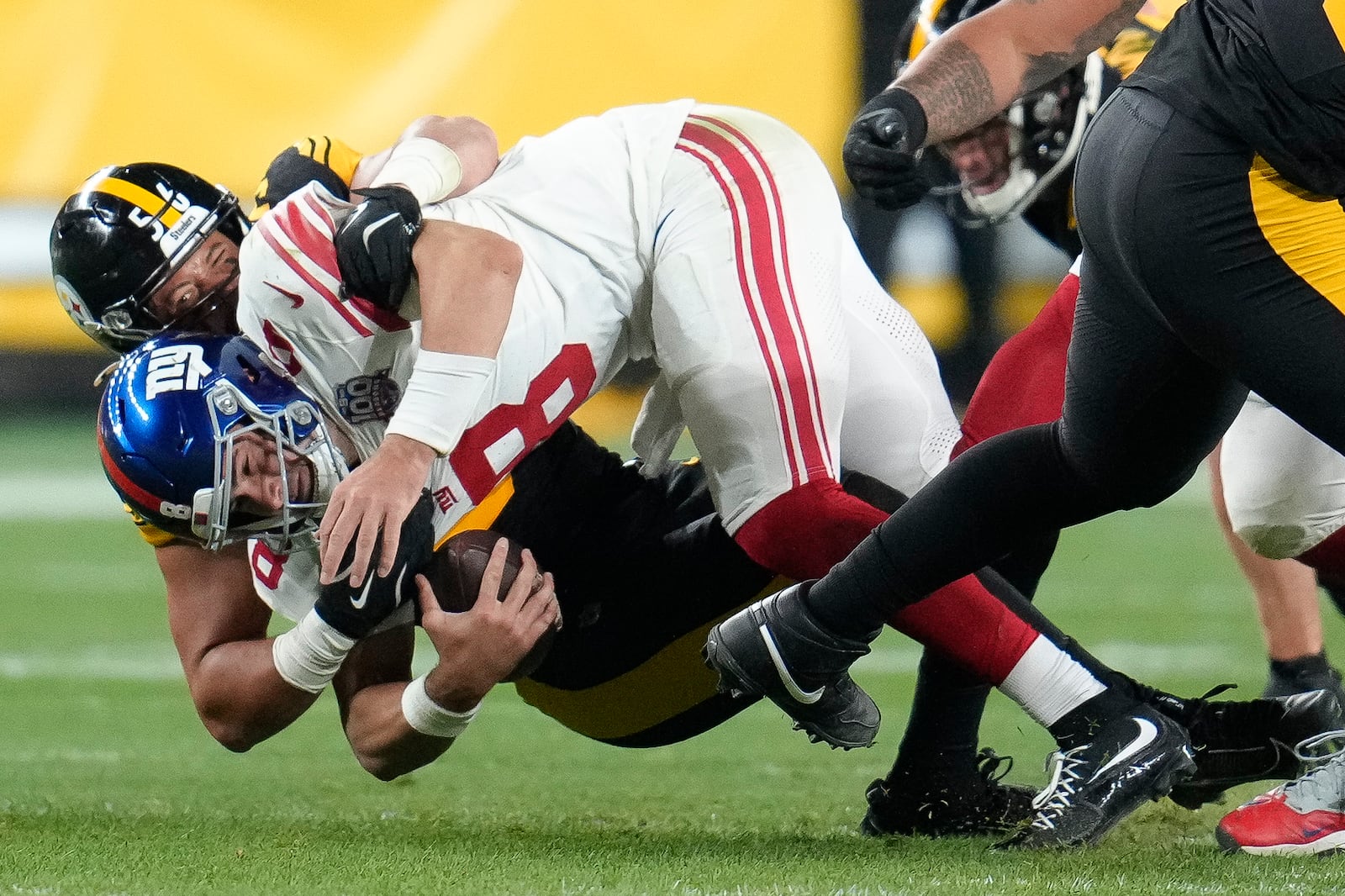 New York Giants quarterback Daniel Jones (8) is sacked by Pittsburgh Steelers linebacker Alex Highsmith during the second half of an NFL football game Monday, Oct. 28, 2024, in Pittsburgh. (AP Photo/Gene J. Puskar)