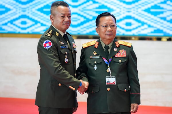 Laos' Defense Minister Chansamone Chanyalath, right, greets Cambodian Defense Minister Tea Seiha during the Association of Southeast Asian Nations (ASEAN) defense ministers' meeting in Vientiane, Laos, Wednesday, Nov. 20, 2024. (AP Photo/Anupam Nath)