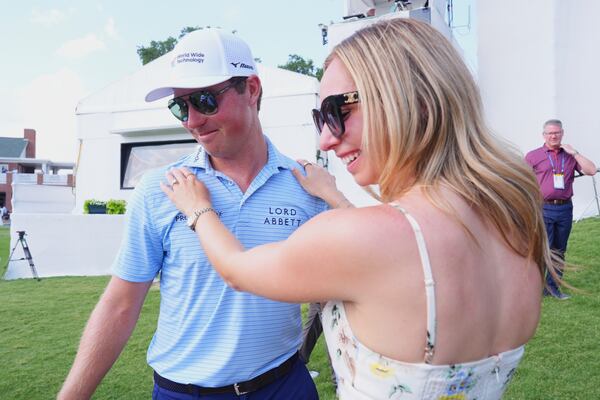 Ben Griffin, left, celebrates with fiance Dana Myeroff after winning the Charles Schwab Challenge golf tournament at Colonial Country Club in Fort Worth, Texas, Sunday, May 25, 2025. (AP Photo/LM Otero)