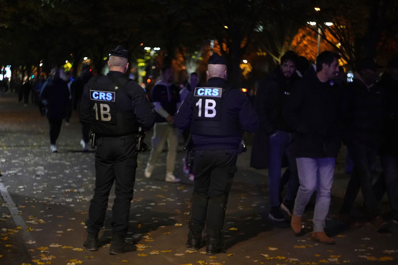 Police officers watch supporters arriving ahead of the Nations League soccer match France against Israel outside the Stade de France stadium, Thursday, Nov. 14, 2024 in Saint-Denis, outside Paris. (AP Photo/Aurelien Morissard)