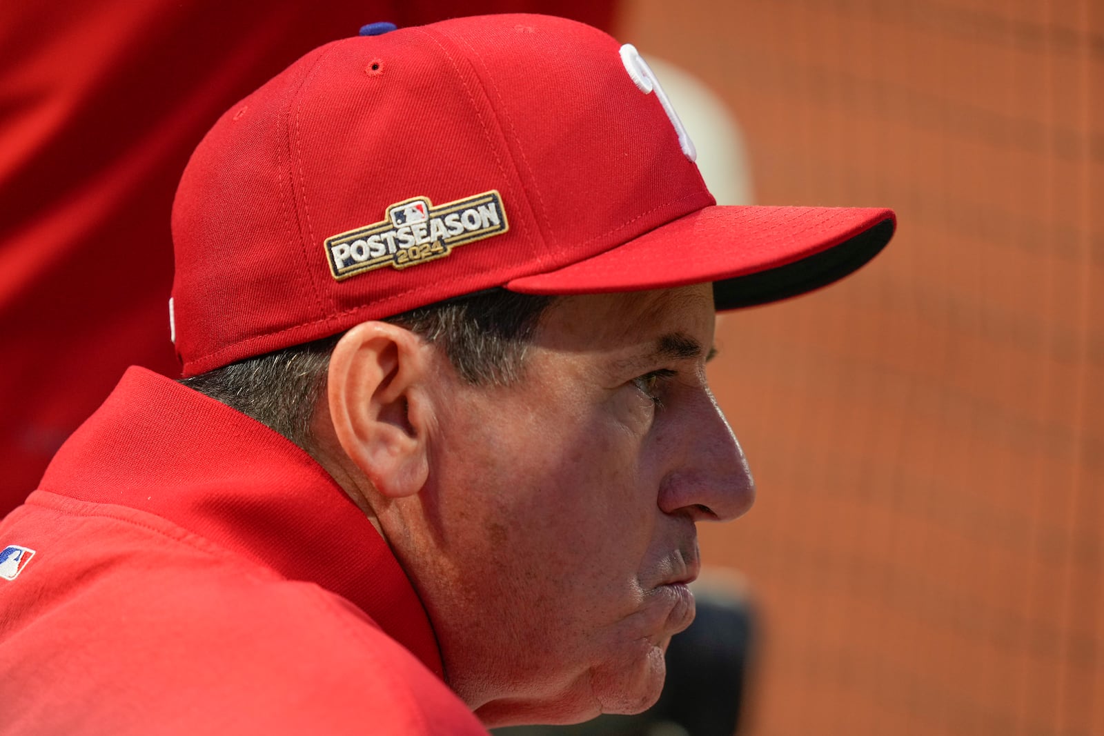 Philadelphia Phillies manager Rob Thomson (59) watches play against the New York Mets from the dugout during the fourth inning of Game 3 of the National League baseball playoff series, Tuesday, Oct. 8, 2024, in New York. (AP Photo/Seth Wenig)