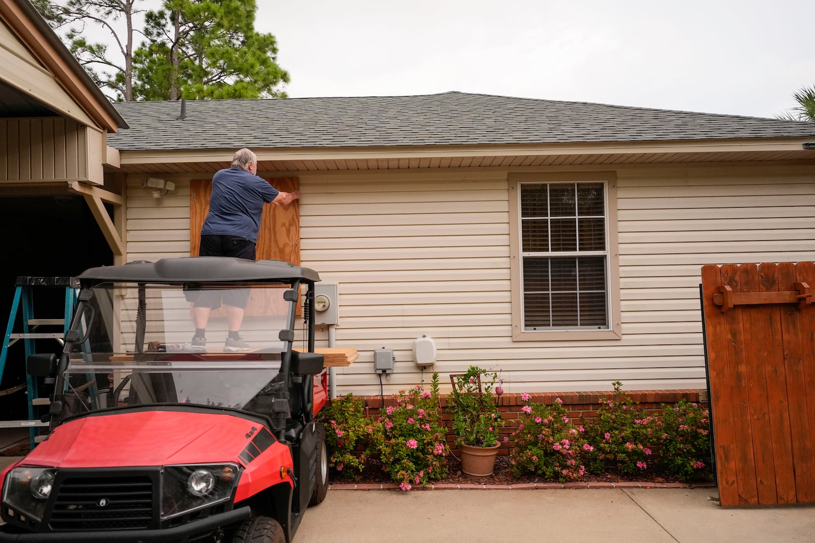 Dave McCurley boards up the windows to his home in advance of Tropical Storm Helene, expected to make landfall as a hurricane, in Ochlockonee Bay, Fla., Wednesday, Sept. 25, 2024. (AP Photo/Gerald Herbert)