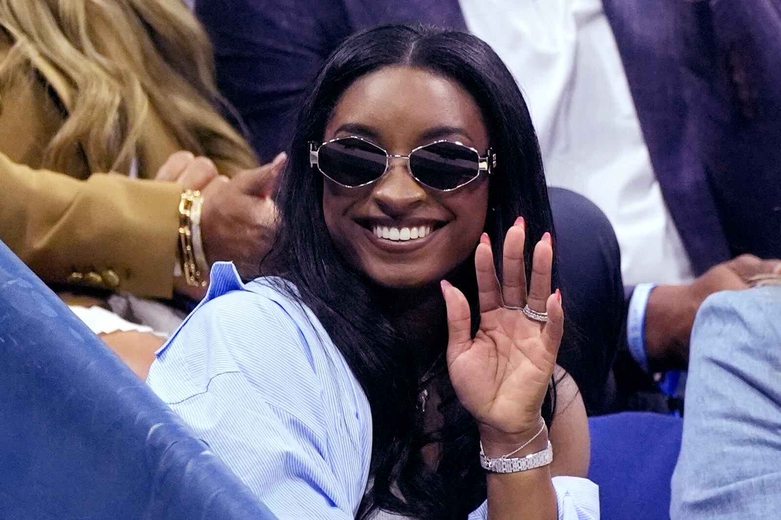 Olympic gold medalist Simone Biles waves during a break in a match between Jessica Pegula, of the United States, and Iga Świątek, of Poland, during the quarterfinals of the U.S. Open tennis championships, Wednesday, Sept. 4, 2024, in New York. (AP Photo/Eduardo Munoz Alvarez)