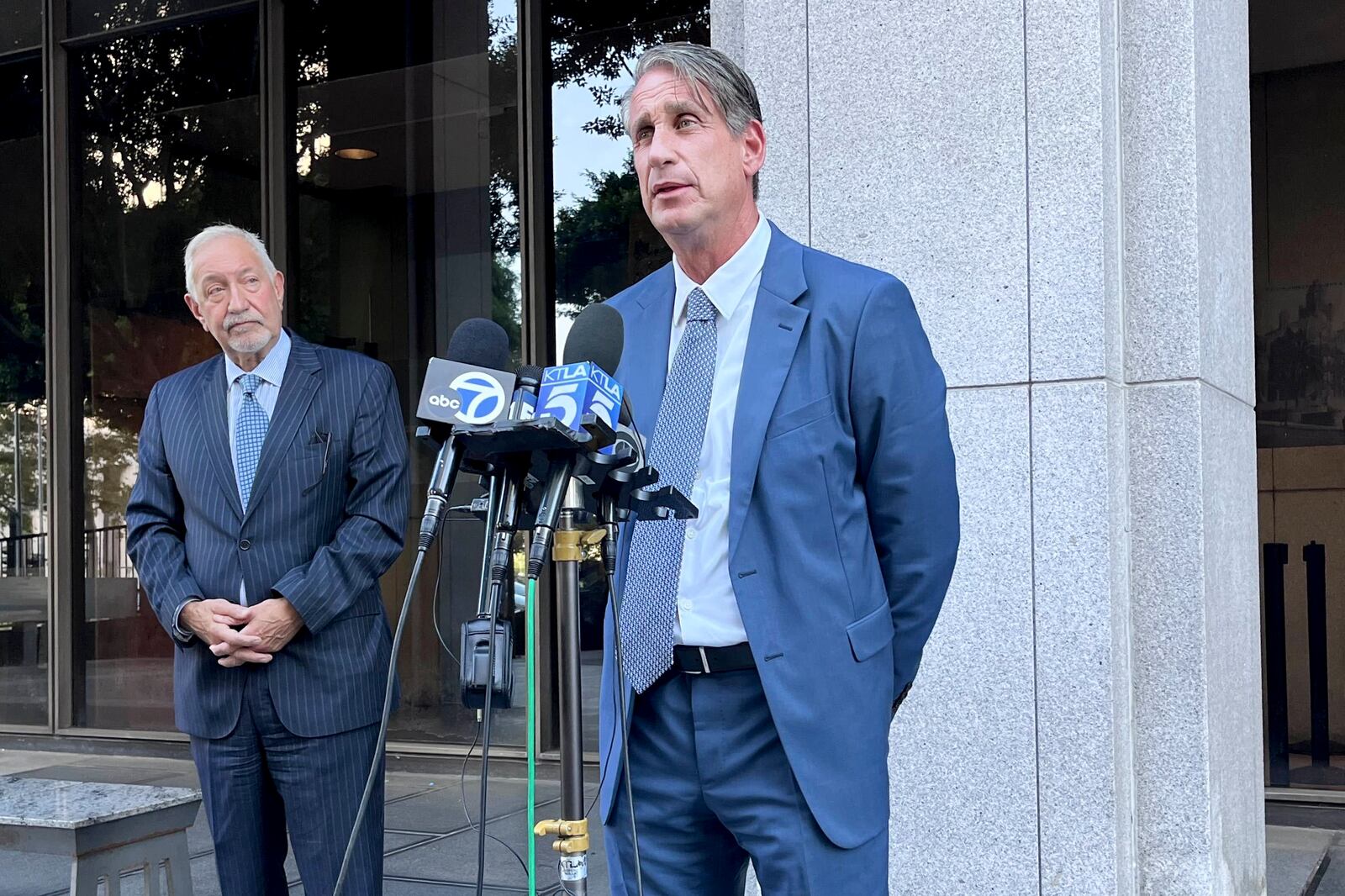 Attorneys Bryan Freedman, center, and Mark Geragos, left, address the media on developments on the case of brothers Lyle and Erik Menendez, both serving life sentences for the murder of their parents in 1989, Thursday, Oct. 3, 2024 in Los Angeles. (AP Photo/Jaimie Ding)