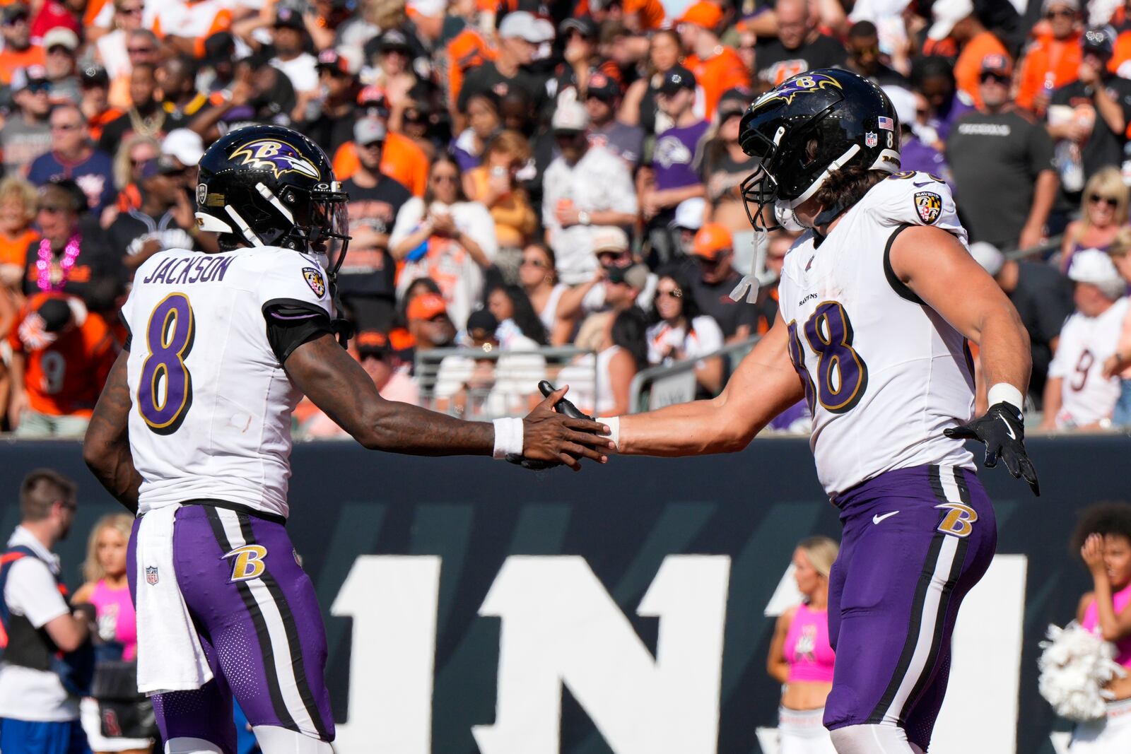 Baltimore Ravens quarterback Lamar Jackson (8) and tight end Charlie Kolar (88) react after they connected for a touchdown pass and catch against the Cincinnati Bengals during the second half of an NFL football game, Sunday, Oct. 6, 2024, in Cincinnati. (AP Photo/Jeff Dean)