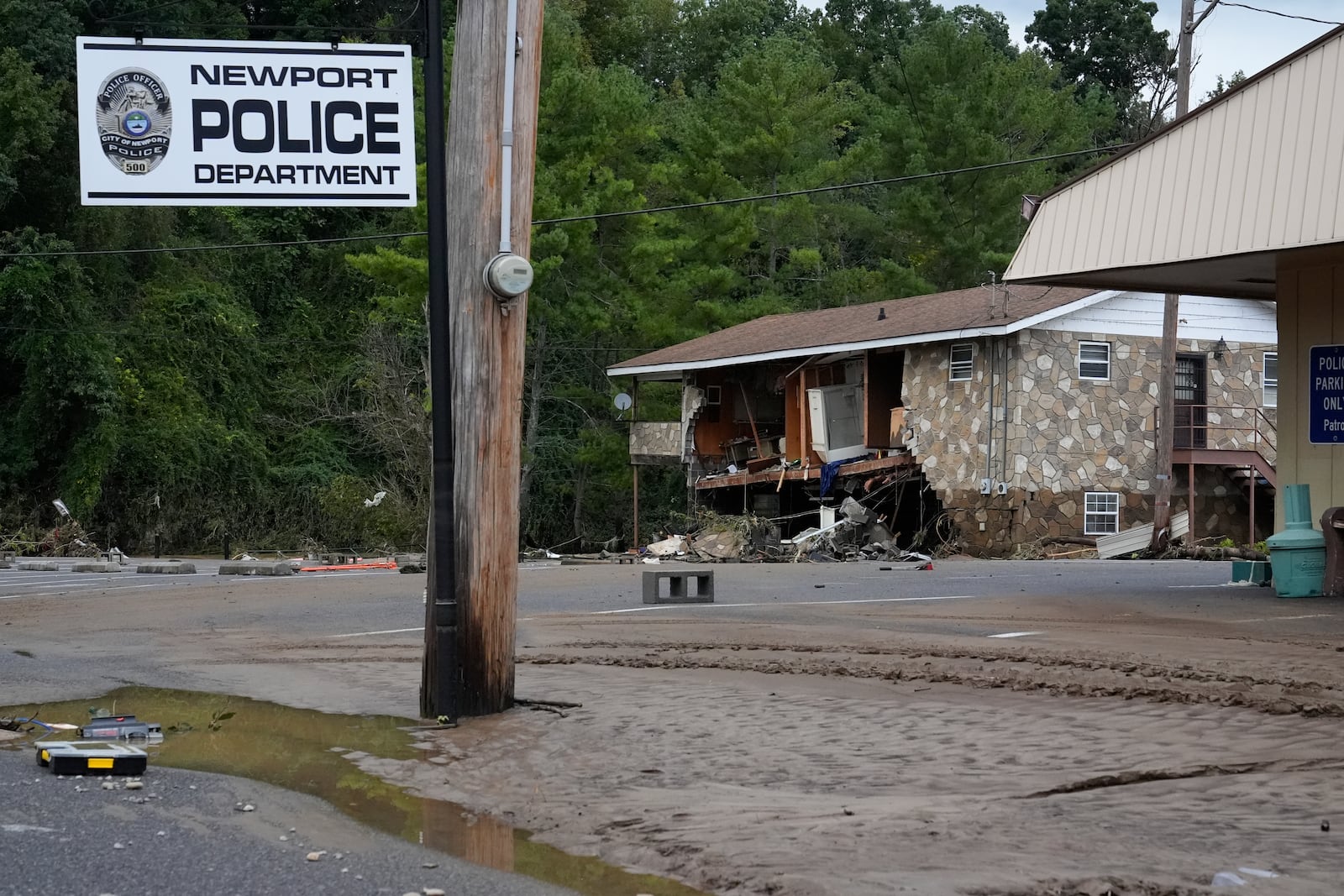 A flood damaged building and debris left by tropical depression Helene is seen in Newport, Tenn., Saturday, Sept. 28, 2024. (AP Photo/George Walker IV)