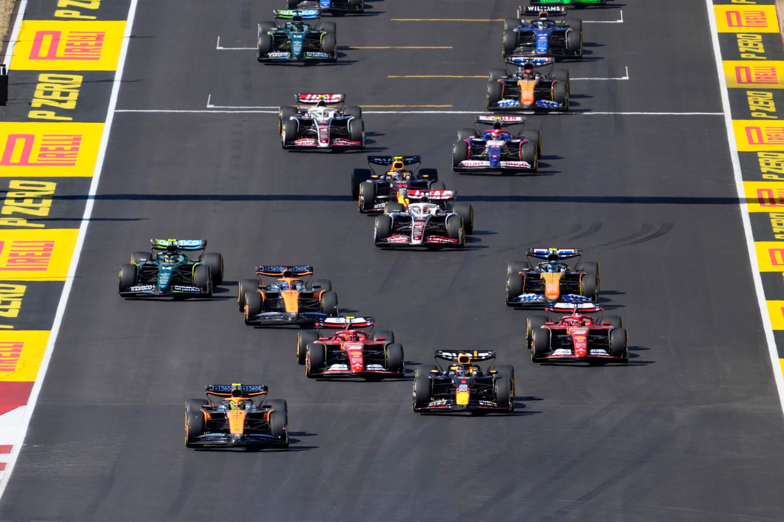 McLaren driver Lando Norris, left front, of Britain, and Red Bull driver Max Verstappen, right front, of the Netherlands, lead drivers at the start of the U.S. Grand Prix auto race at Circuit of the Americas, Sunday, Oct. 20, 2024, in Austin, Texas. (AP Photo/Eric Gay)