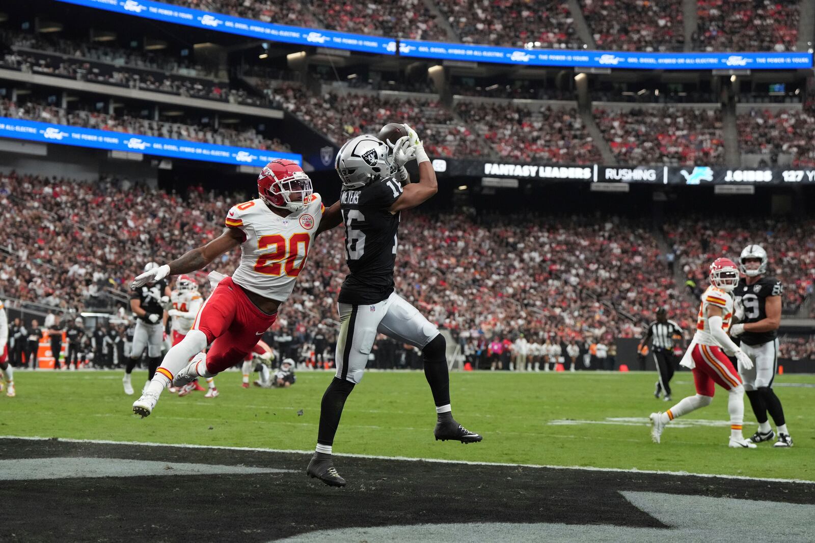 Las Vegas Raiders wide receiver Jakobi Meyers (16) catches a touchdown pass as Kansas City Chiefs safety Justin Reid (20) defends during the first half of an NFL football game Sunday, Oct. 27, 2024, in Las Vegas. (AP Photo/Rick Scuteri)