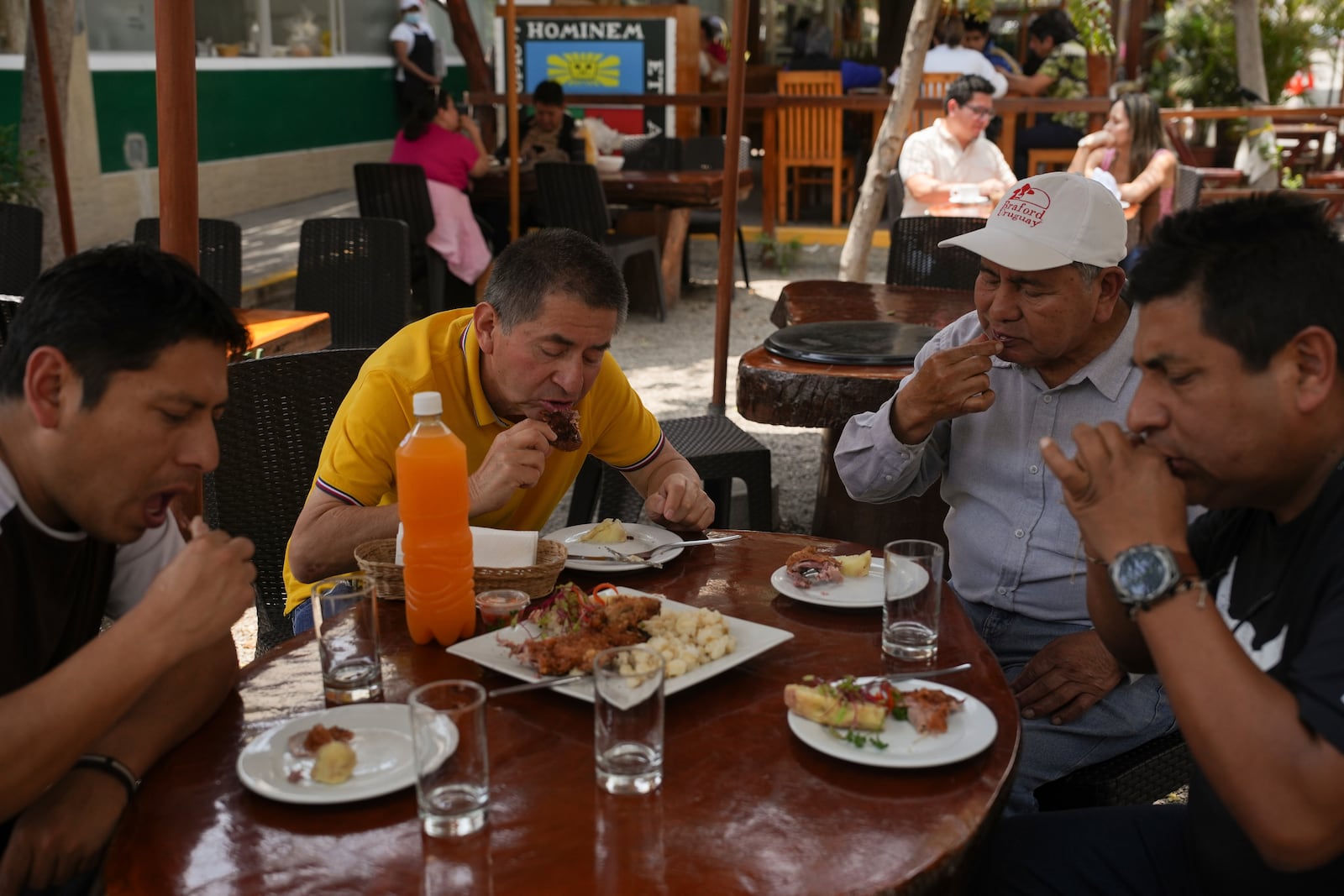 Costumers eat guinea pig at a restaurant in Lima, Peru, Thursday, Oct. 3, 2024. Guinea pigs, locally known as 'cuy,' have been traditionally raised for meat consumption since pre-Inca times. (AP Photo/Guadalupe Pardo)