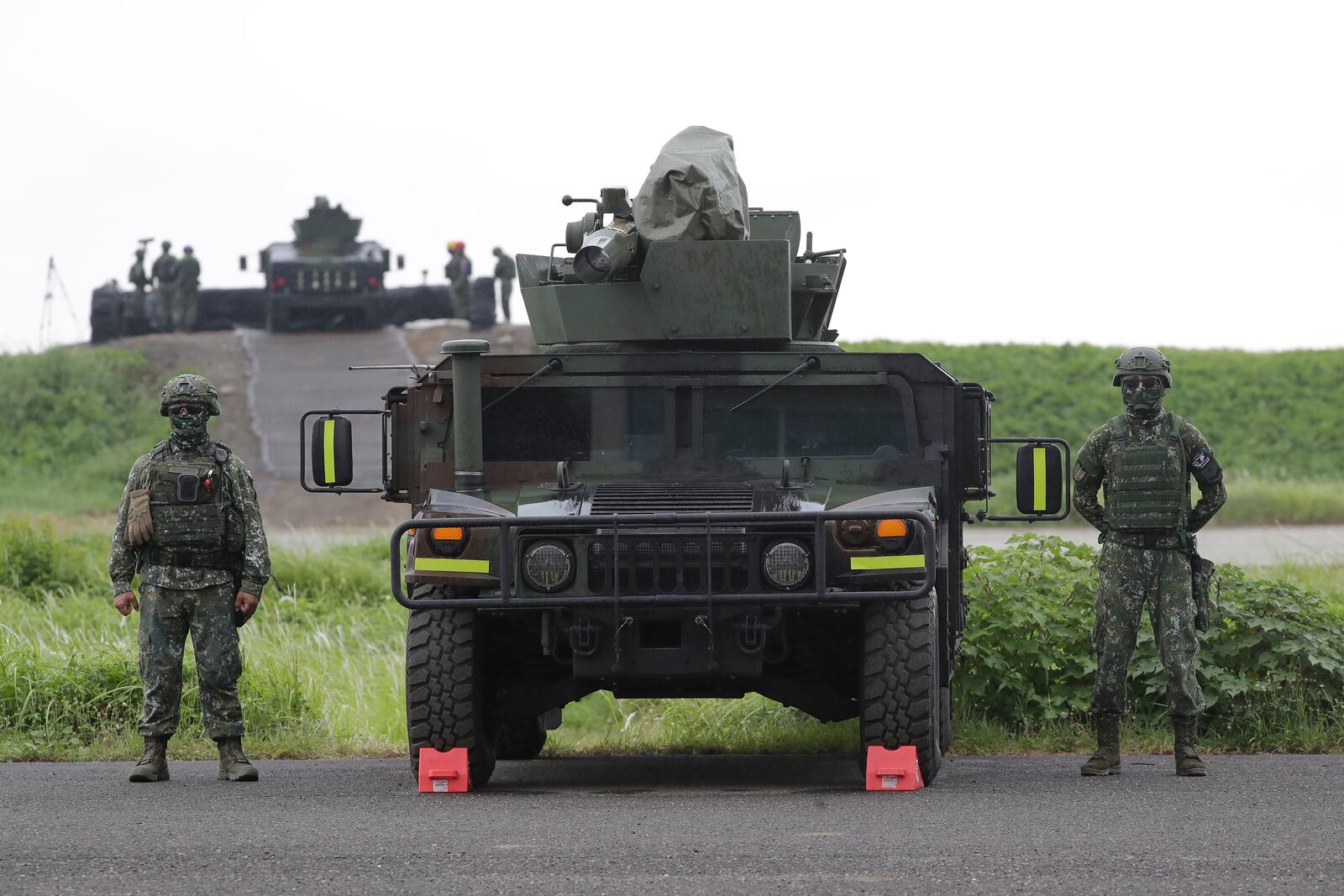 FILE - Soldiers stand beside a M1167 HMMWV (High Mobility Multipurpose Wheeled Vehicle) anti-tank missile carriers during military drills in Pingtung County, southern Taiwan, Monday, Aug. 26, 2024. (AP Photo/Chiang Ying-ying, File)